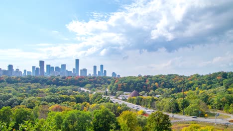 fall time highway leading to downtown skyline on cloudy day