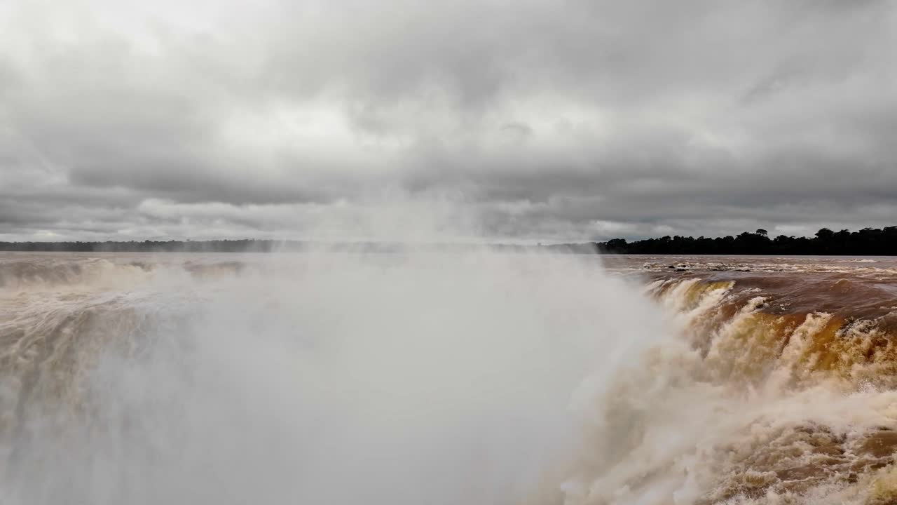 A breathtaking, dramatic shot of Iguazu Falls, the world's largest waterfall system. Captured from the Argentina-Brazil border, showcasing the upper and lower Iguazu River in all its natural glory.