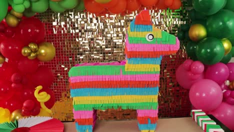 cinco de mayo celebration with mexican pinata burrito set against balloons and golden backdrop