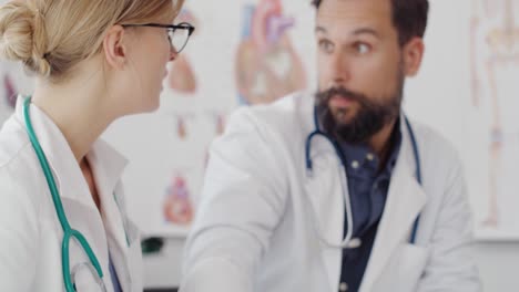 Handheld-view-of-two-busy-doctors-discussing-medical-options