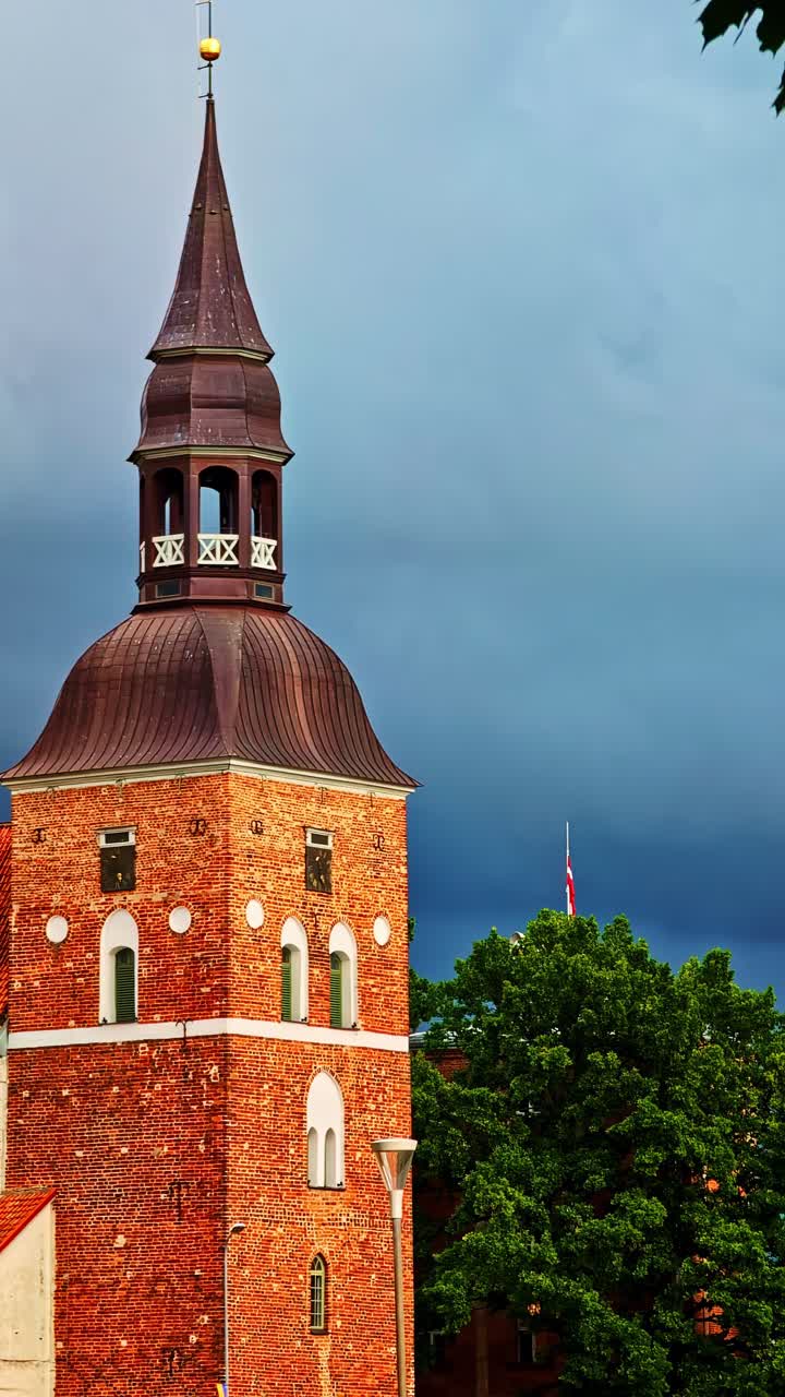 Historic St. Simon's church in Valmiera, Latvia, showing a brick tower and copper spire