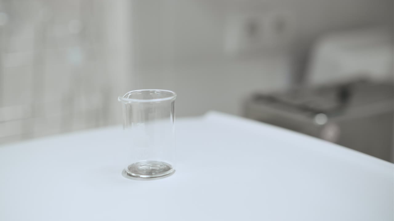 Close up laboratory woker filling the bealer with solvent from the wash bottle