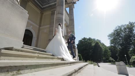 elegant wedding couple near the old building. elegant wedding couple walking near the old building in summer park