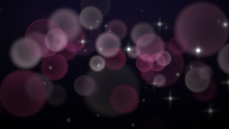 fly pink and purple particles and round bokeh on dark background