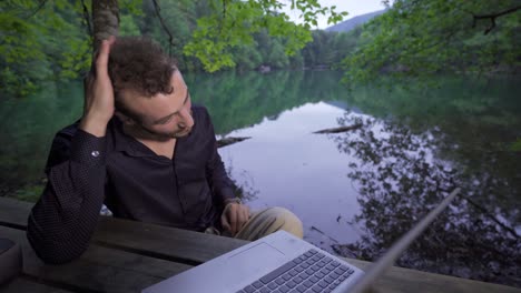 businessman happily working in the forest.