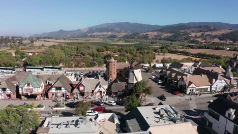 low push-in aerial shot of a windmill in the unique danish village of solvang in central california