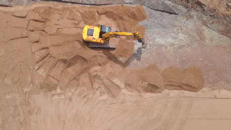 Building-site,-top-down-shot-excavator-clearing-ground