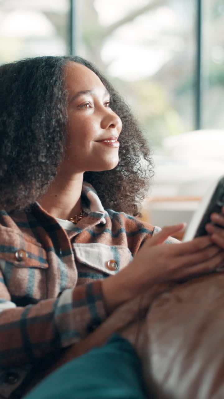 Young Woman Smiling While Using Smartphone Indoors