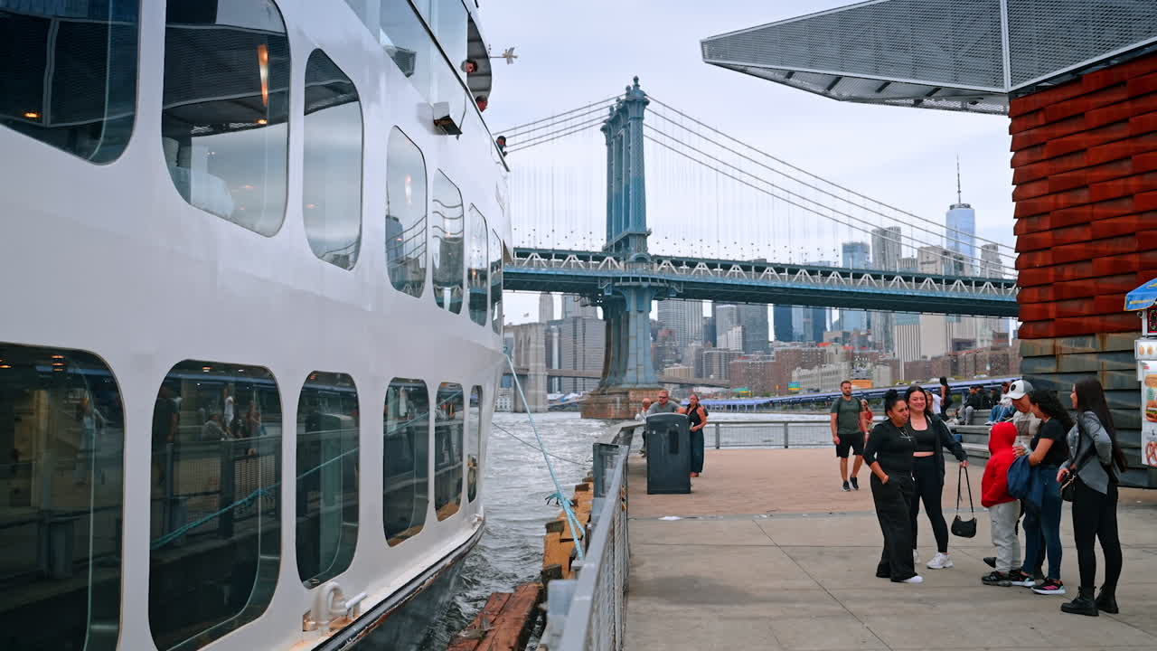 People standing at the pier in New York, USA. Multi-deck boat is getting ready for the river cruise by the Hudson