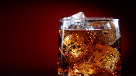 Glass-of-cola.-Ice-cola-with-splashing-bubbles-slow-motion.