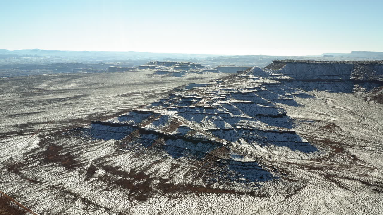 Snow-dusted desert mountains under a clear sky
