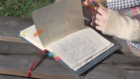 female student looking through her notebook