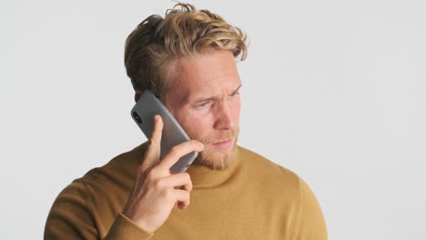 worried caucasian man talking via phone