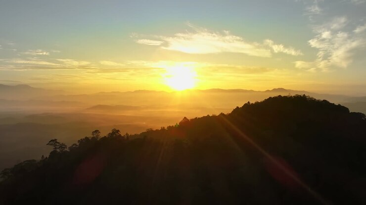 Aerial view Drone flying through the fog above mountain peak Beautiful light sunrise or sunset nature Landscape Amazing video cinematic nature view in Thailand