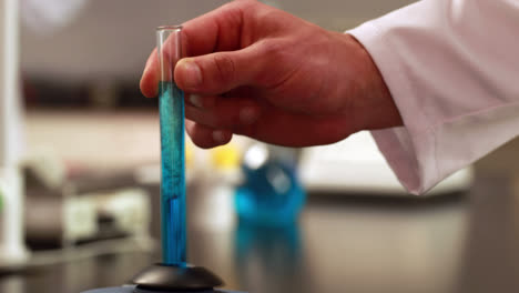 scientist mixing test tube with centrifuge