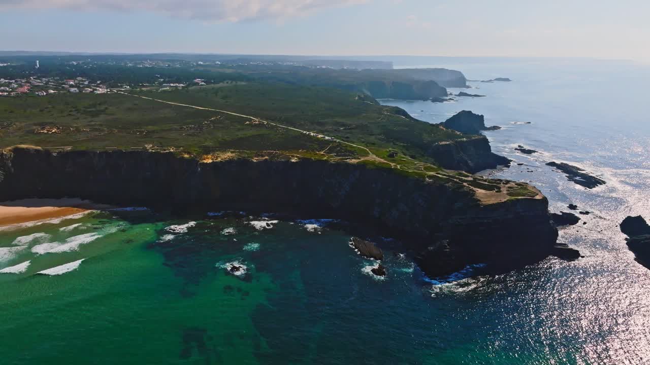High-altitude drone shot of the picturesque landscape of Medo de Fonte Santa, capturing the lush greenery, dramatic cliffs, and turquoise waters.