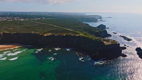 high-altitude drone shot of the picturesque landscape of medo de fonte santa, capturing the lush greenery, dramatic cliffs, and turquoise waters.