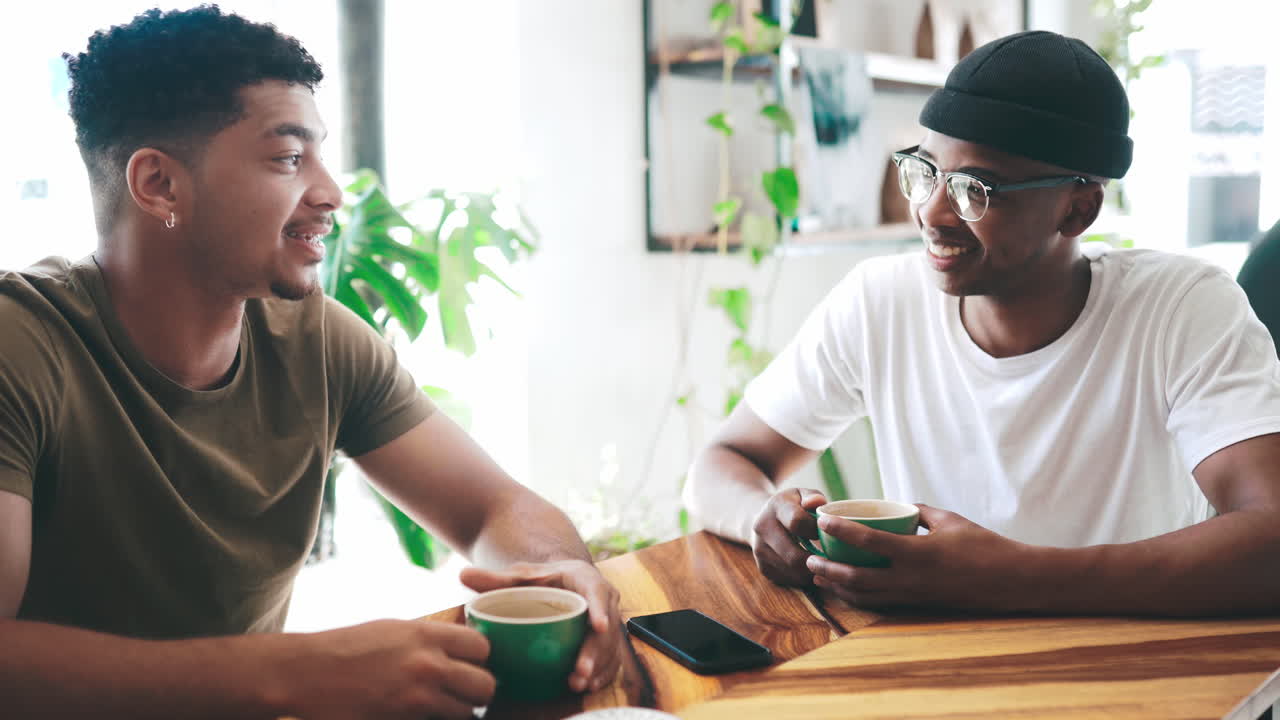 two young men chatting over coffee in a coffee