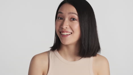 asian woman smiling on camera.