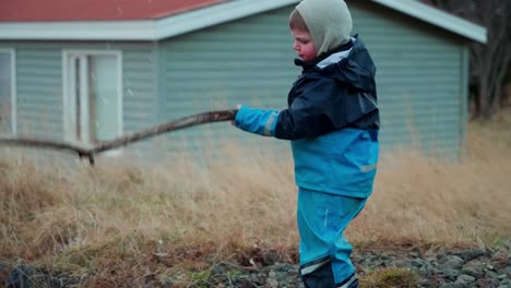 Young-boy-playing-by-a-small-stream-in-the-countryside