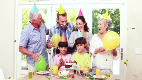 family celebrating birthday with balloons and cake, confetti animation over scene