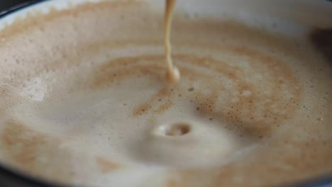 pouring coffee into cappuccino
