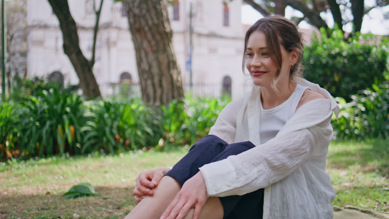 Woman throwing pet toy sitting green park feeling relaxed closeup. Smiling lady