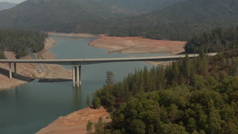 aerial view of highway bridge over shasta lake in northern california low water levels during drought