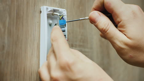 electricista monta sensor de movimiento infrarrojo para sistema de alarma