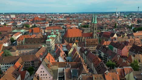4k aerial drone video of the copper-clad twin spiers on the beautiful st. sebald church in downtown nurnberg, germany