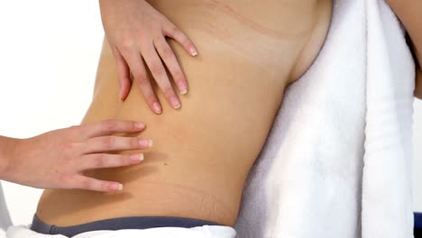 Close-up-of-woman-therapist-massaging-the-back-of-her-patient