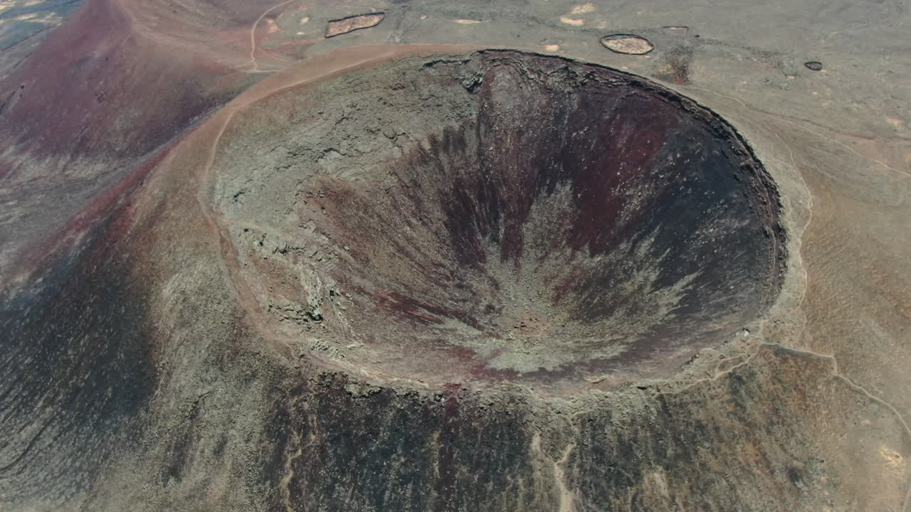 Drone shot over the crater of one of the Bayuyo Volcanoes is a set of volcanic cones that erupted at the same time, following an almost straight line. Located on the island of Fuerteventura.