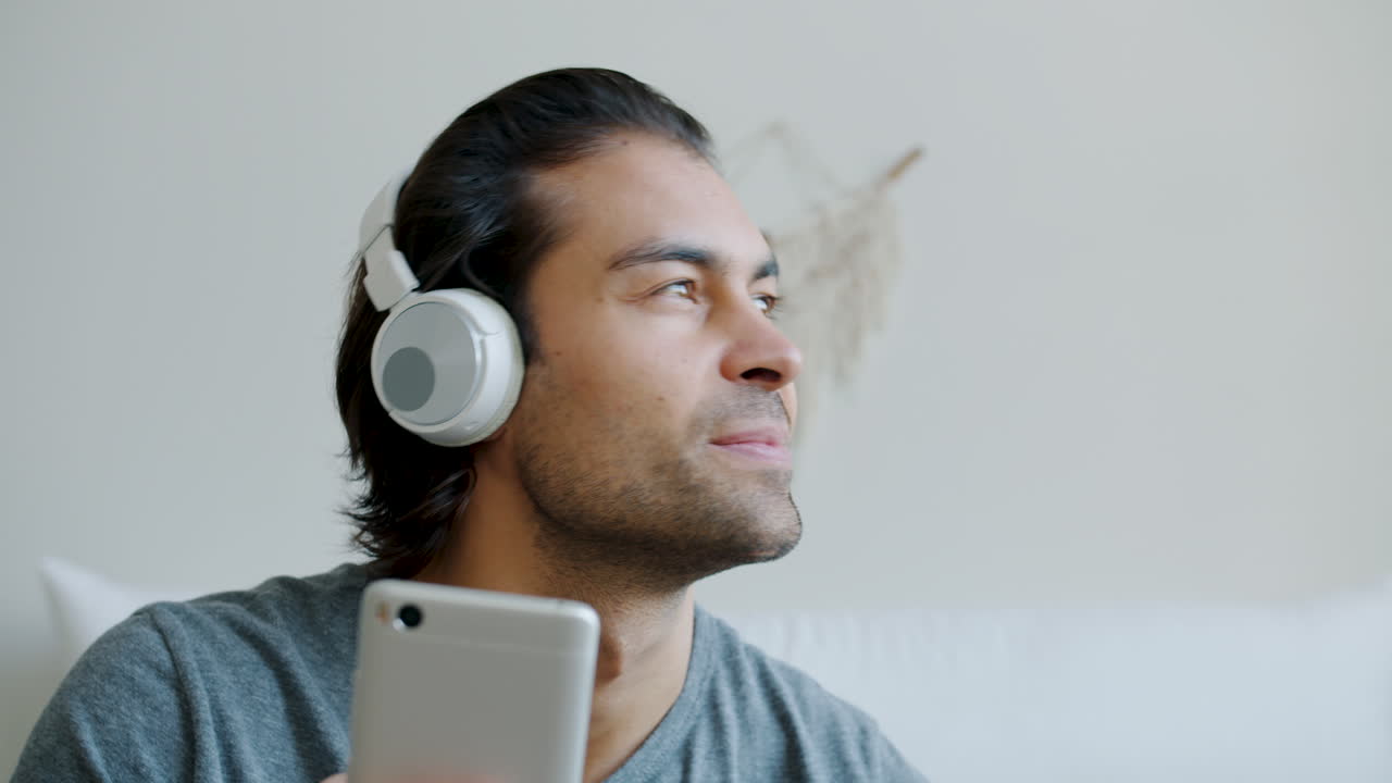 Man using mobile phone and headphones