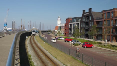 urban waterfront scene with train tracks and lighthouse in a european city