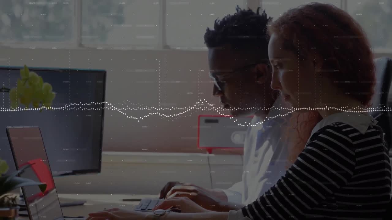 Animation of graphs and changing numbers over multiracial coworkers working on laptop in office