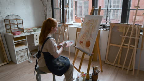 artist painting on a canvas