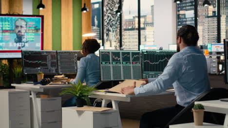 traders in office follow breaking news tv coverage of rare black swan event