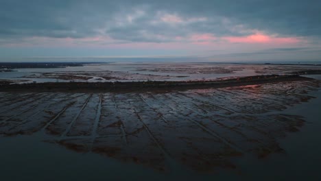 an aerial view over the salt marsh in freeport, ny during a cloudy sunset