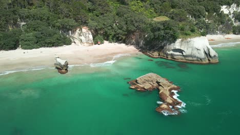 Cinematic-flight-around-Cathedral-cove,-New-Zealand