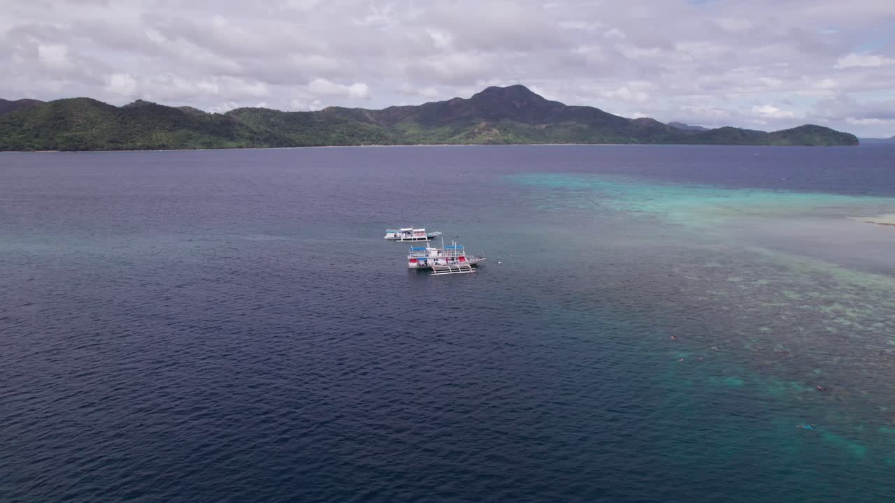 Drone Shot of Traditional Bangka Filipino Boats Anchored in Sea by Dipalian Island, Philippines