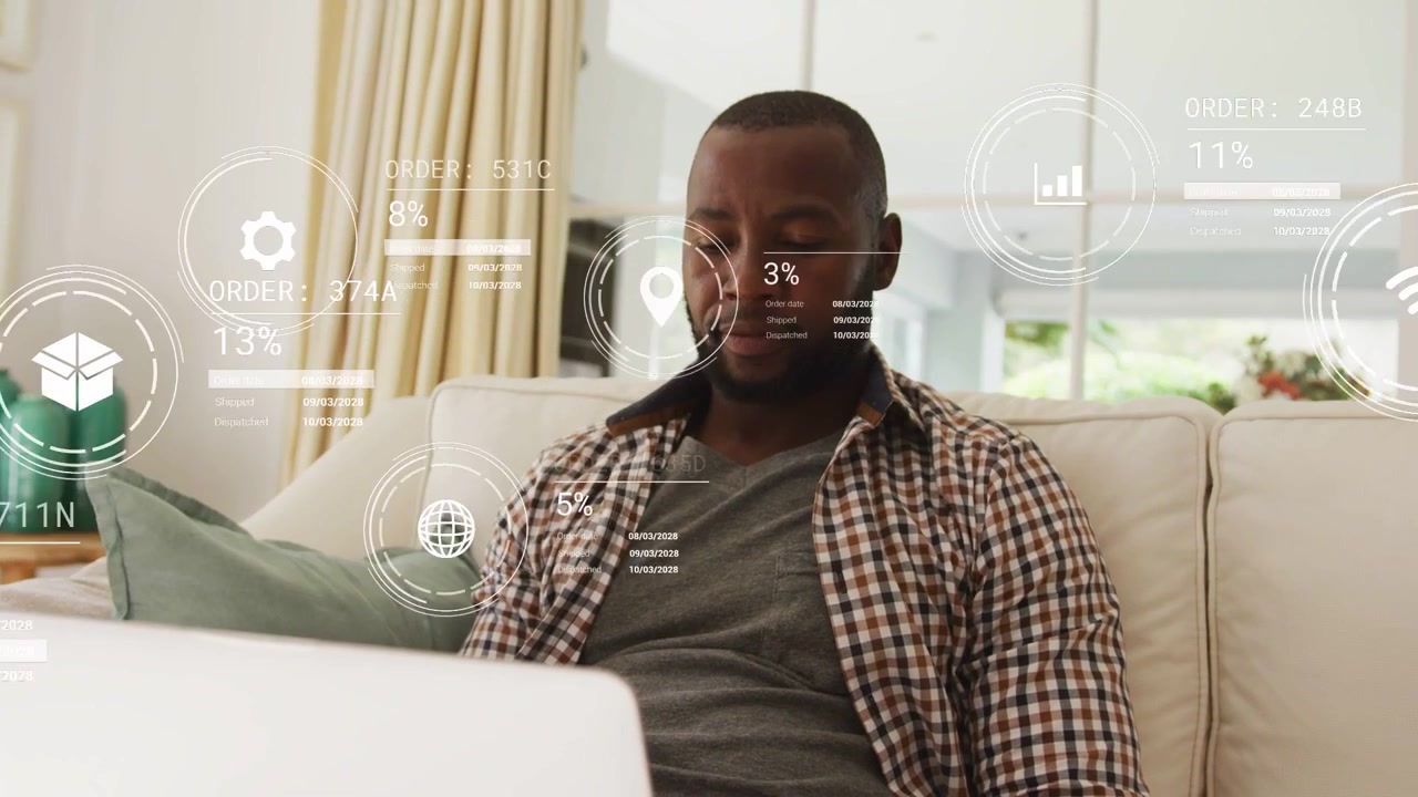 Mature man focusing on laptop, viewing animated HUD icons and charts tracking orders, finances
