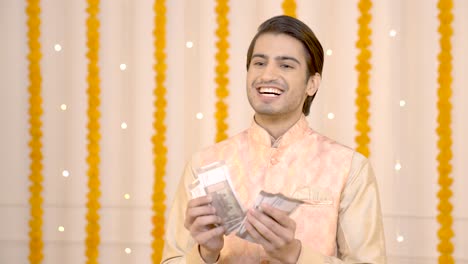 rich indian man counting money