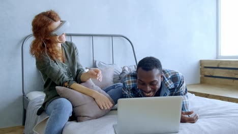 couple using vr headset and laptop