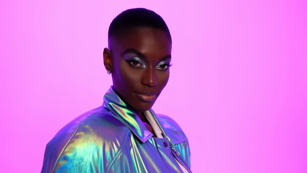 Black Model In Holographic Jacket Poses Confidently Against Neon Pink Studio Backdrop, Dramatic Makeup