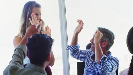 business executives giving high five in office 4k