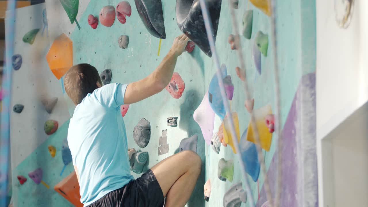 Man Rock Climbing on a Wall
