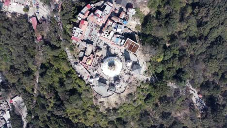 A-rising-straight-down-aerial-view-time-lapse-of-Swayambhunath-Stupa-in-the-city-of-Kathmandu,-Nepal