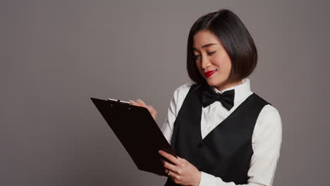 hospitality industry worker making a list of reservations at hotel