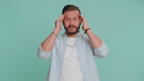 lebanese man rubbing temples to cure headache problem suffering from tension and migaine stress pain