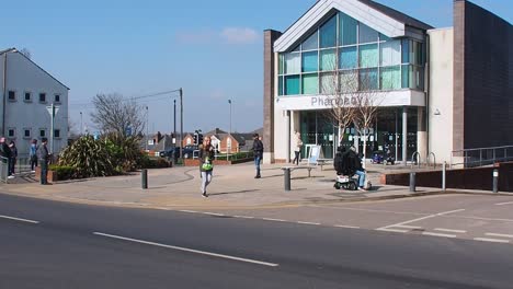 people queue outside pharmacy during the coronavirus pandemic outbreak lockdown wakefield uk england.